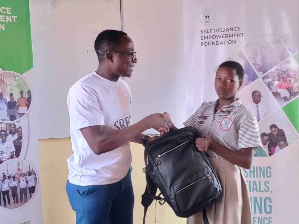 An SREF beneficiary receiving school supplies in Ghana