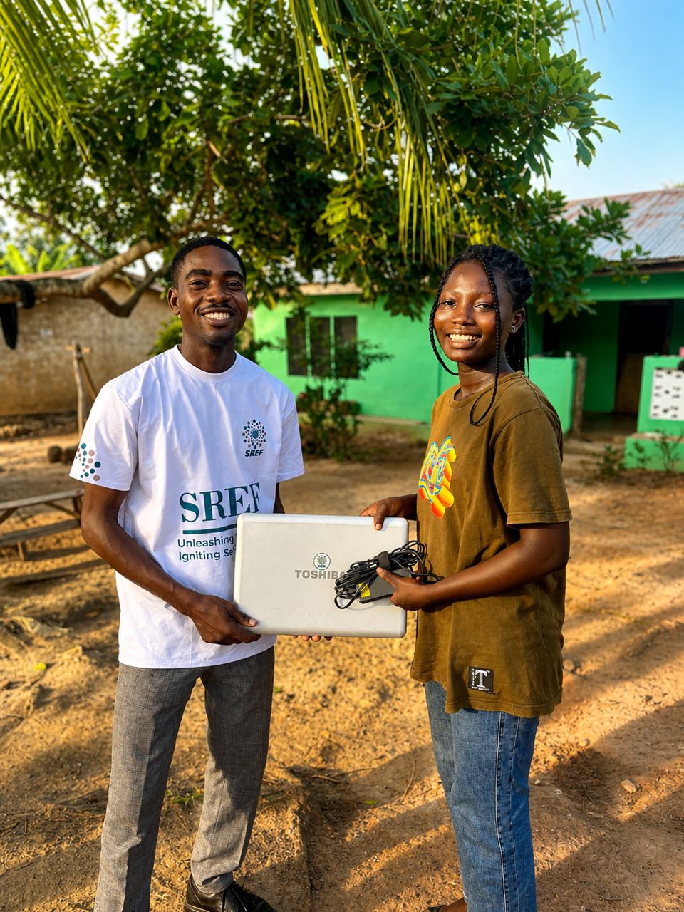 SREF staff handing out school supplies in Ghana